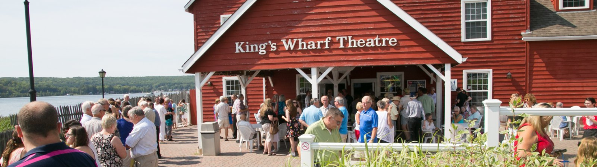 A crowd in front of King's Wharf theatre at an event.
