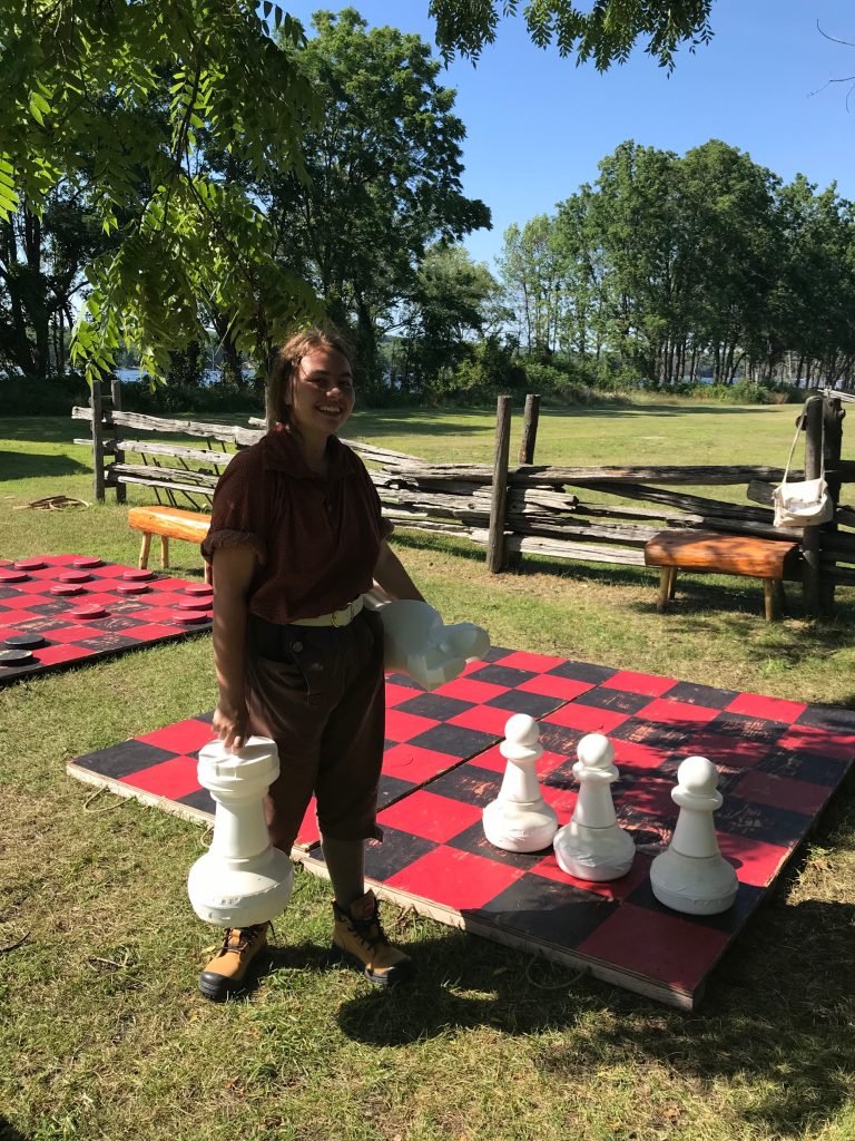 Interpreter in front of giant chess game.