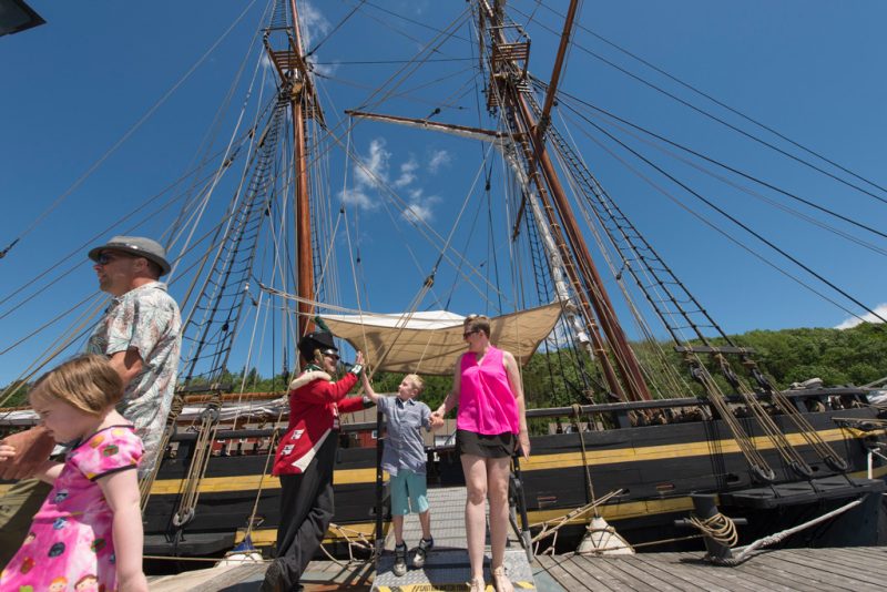 Family touring a sailing ship at Discovery Harbour