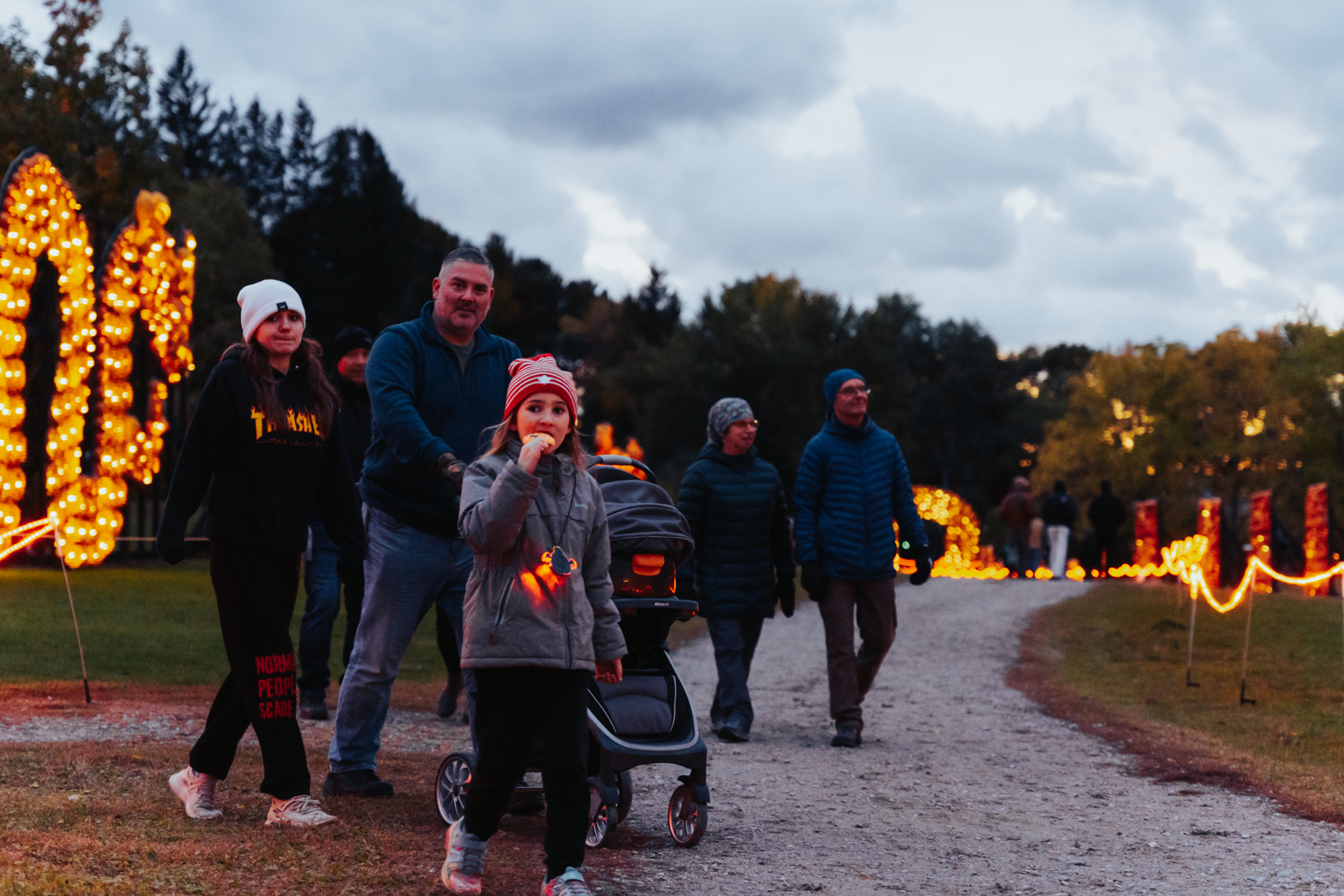 visitors to Discovery Harbour enjoying the sites of thousands of lit funkins on this historic site