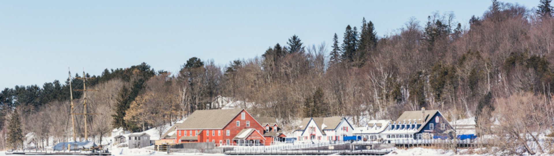 showing a snow-covered Discovery Harbour in winter. A view from the water