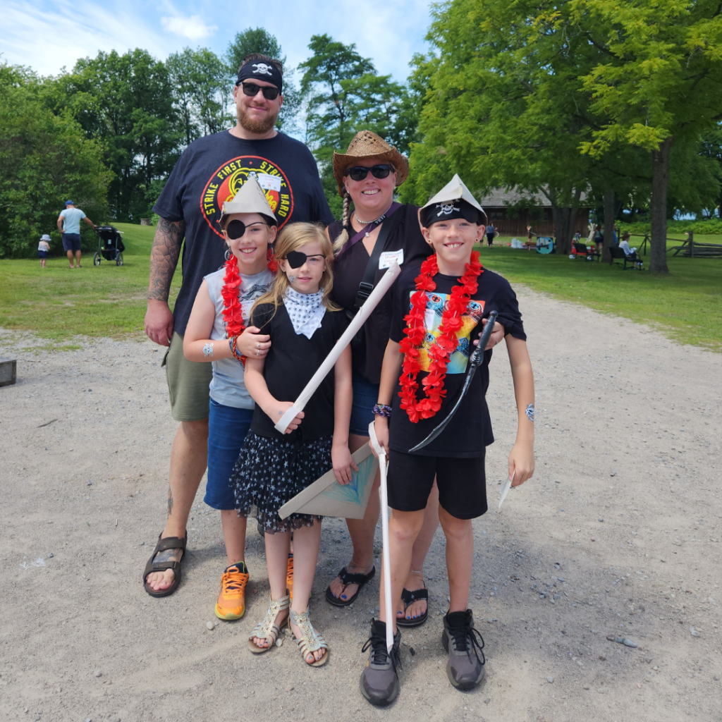 A family dresses up for Pirates of the Bay at Discovery Harbour
