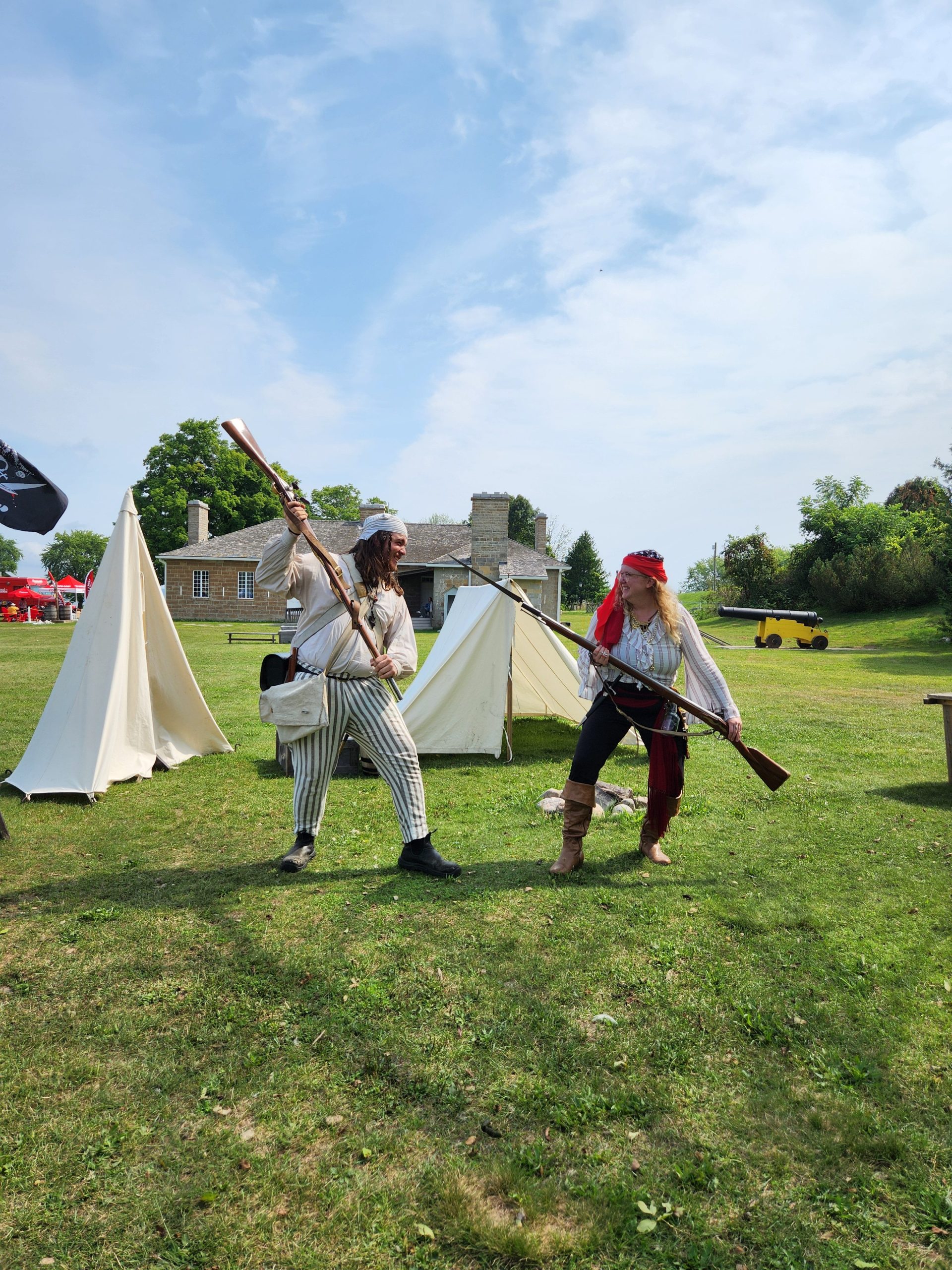 Two pirate interpreters fighting with  historical muskets