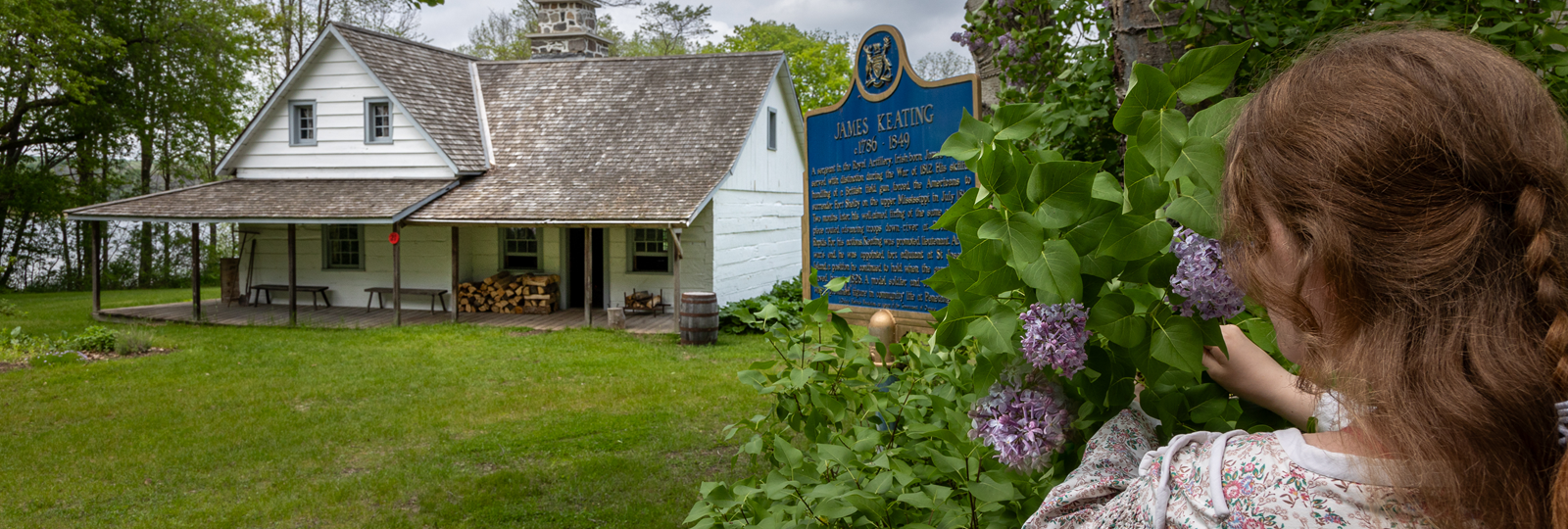 Forgeron interprète montrant à deux jeunes enfants le clou en métal qu’il a foré dans l’atelier du forgeron
