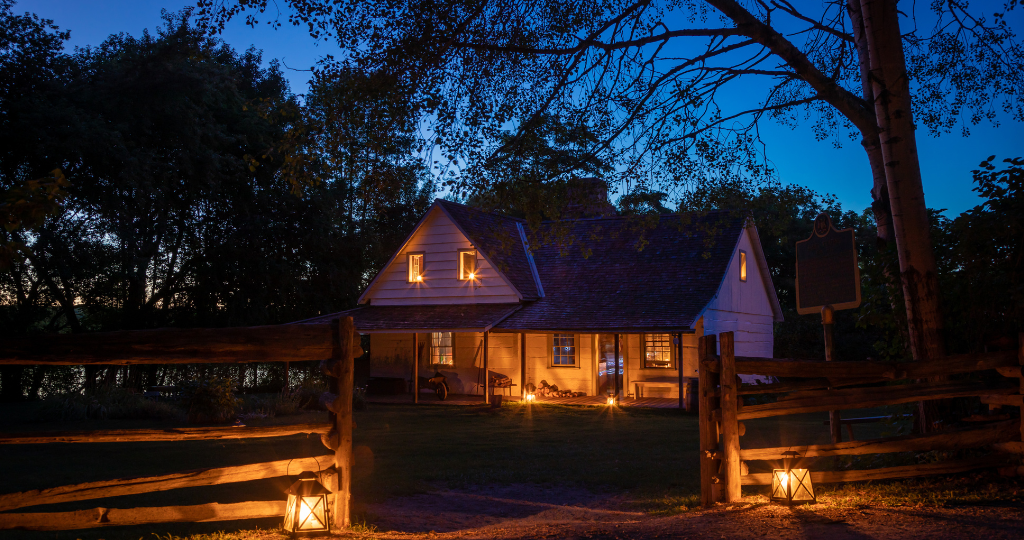 Historic building on site illuminated by lantrens during the ghost tours event