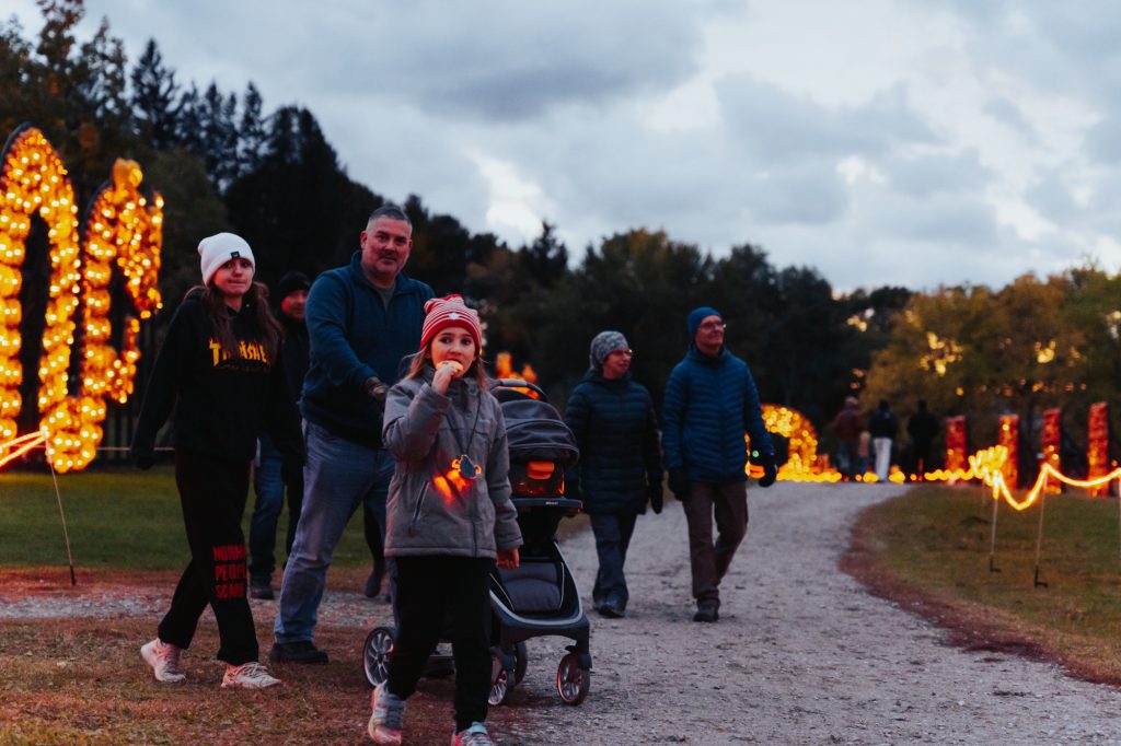 EDCNS_Fall2022_PumpkinfernoEvent_Web-70-1024x682 Guests walking through the pumpkin displays at Discovery Harbour