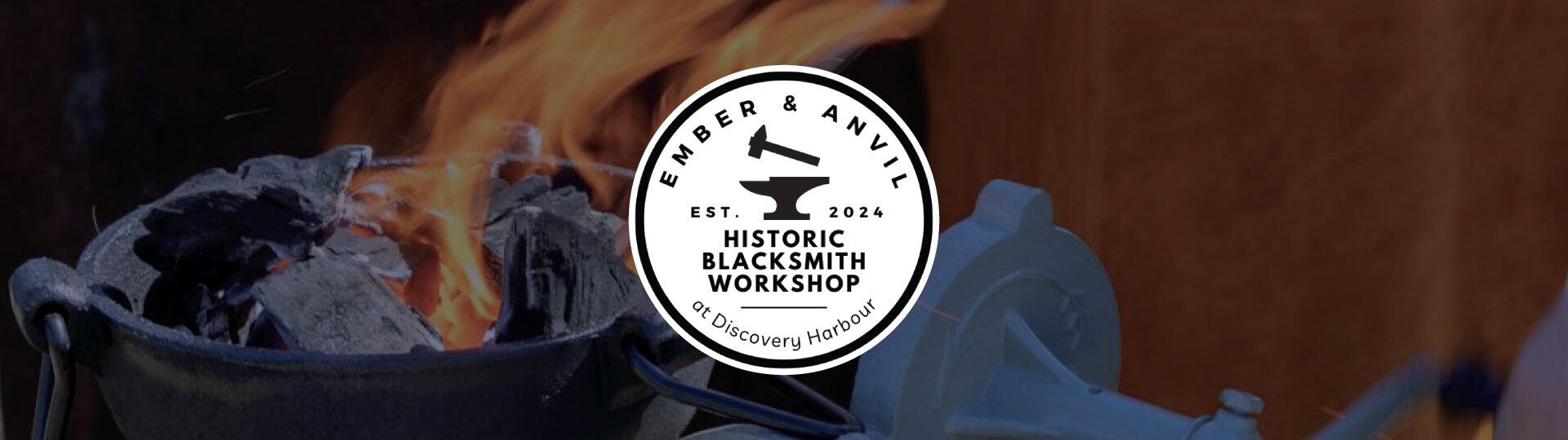 a blacksmith hammering a piece of molten iron into a coathook