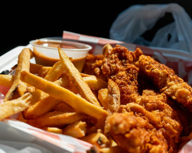 Fries and wings in a takeaway container